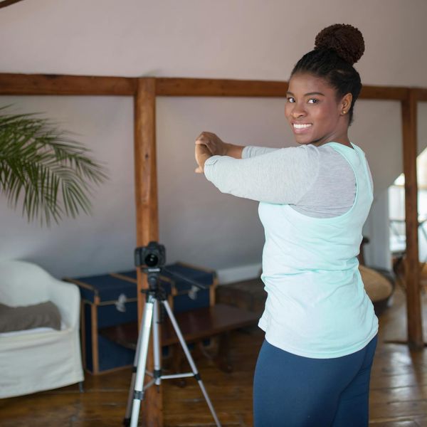 Smiling person feeling energetic after a home workout session.